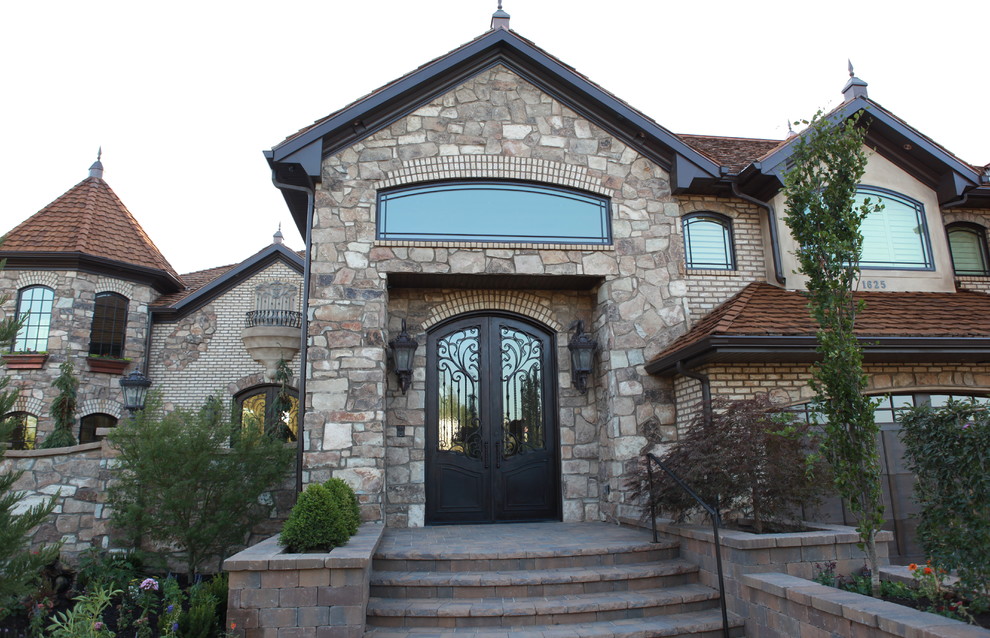 Design ideas for an expansive and brown traditional two floor house exterior in Salt Lake City with stone cladding.