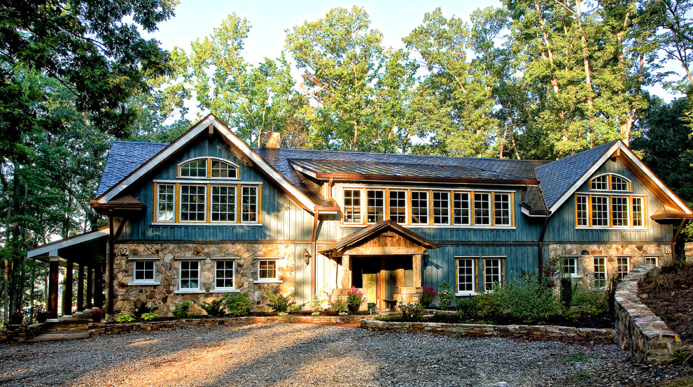 Large mountain style green two-story mixed siding exterior home photo in Richmond with a mixed material roof