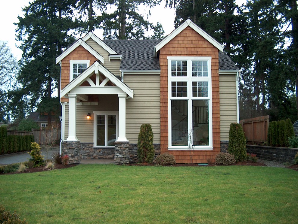 Inspiration for an expansive and beige traditional two floor house exterior in Seattle with mixed cladding.