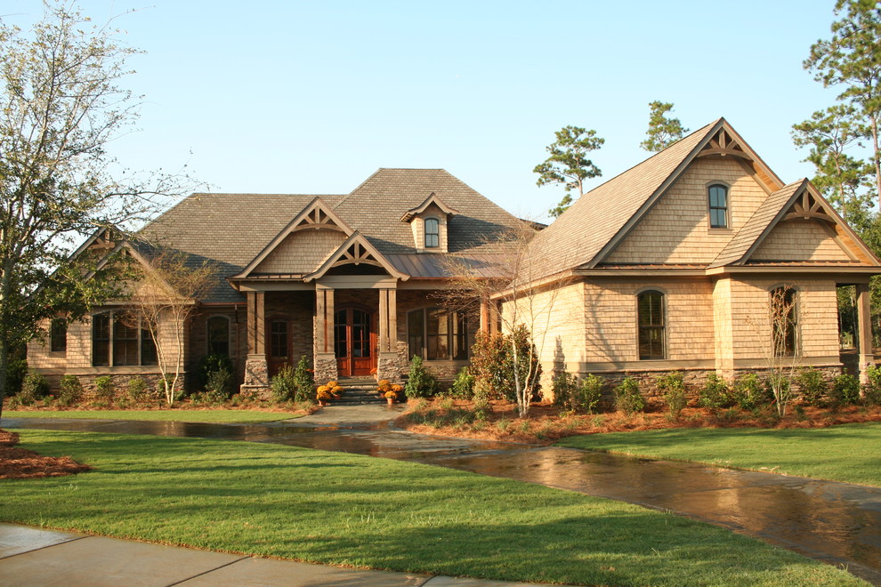 Example of a large mountain style beige two-story vinyl exterior home design in Other with a hip roof