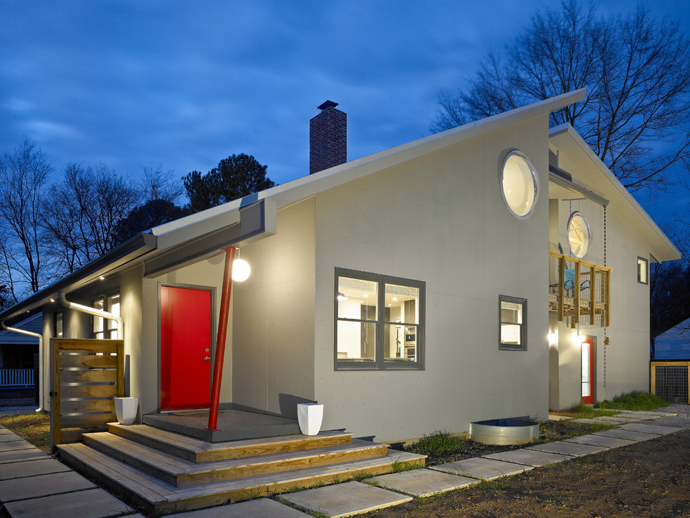 Réalisation d'une façade de maison grise minimaliste à un étage.