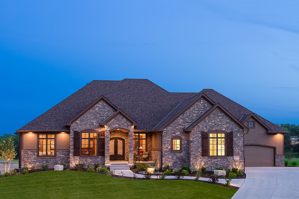 Example of a classic stone exterior home design in Other