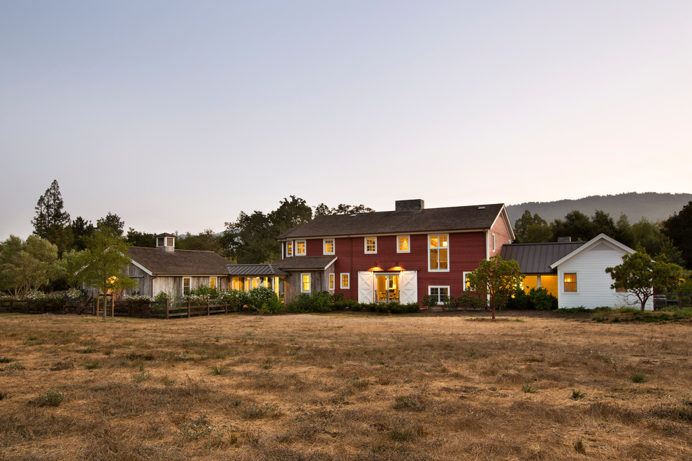 Inspiration for a red rural two floor house exterior in San Francisco with a pitched roof.