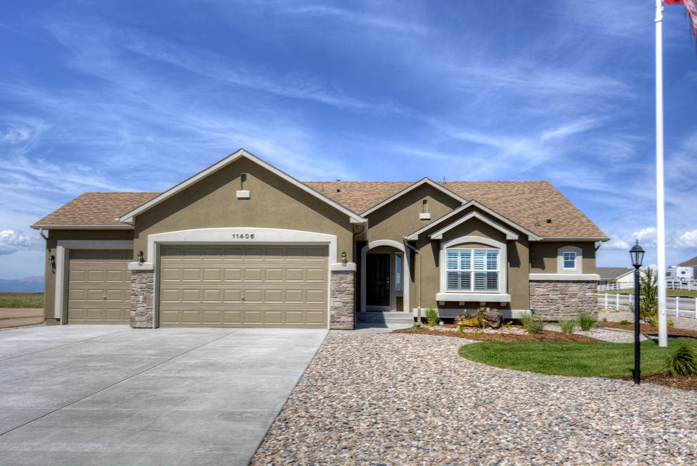 Inspiration for a beige classic bungalow render house exterior in Denver.