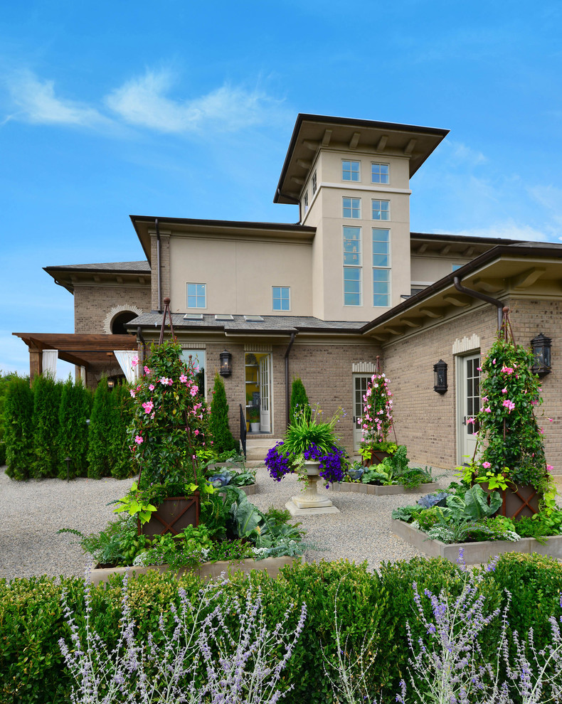 Ejemplo de fachada de casa beige mediterránea grande de dos plantas con revestimientos combinados, tejado a cuatro aguas y tejado de teja de madera