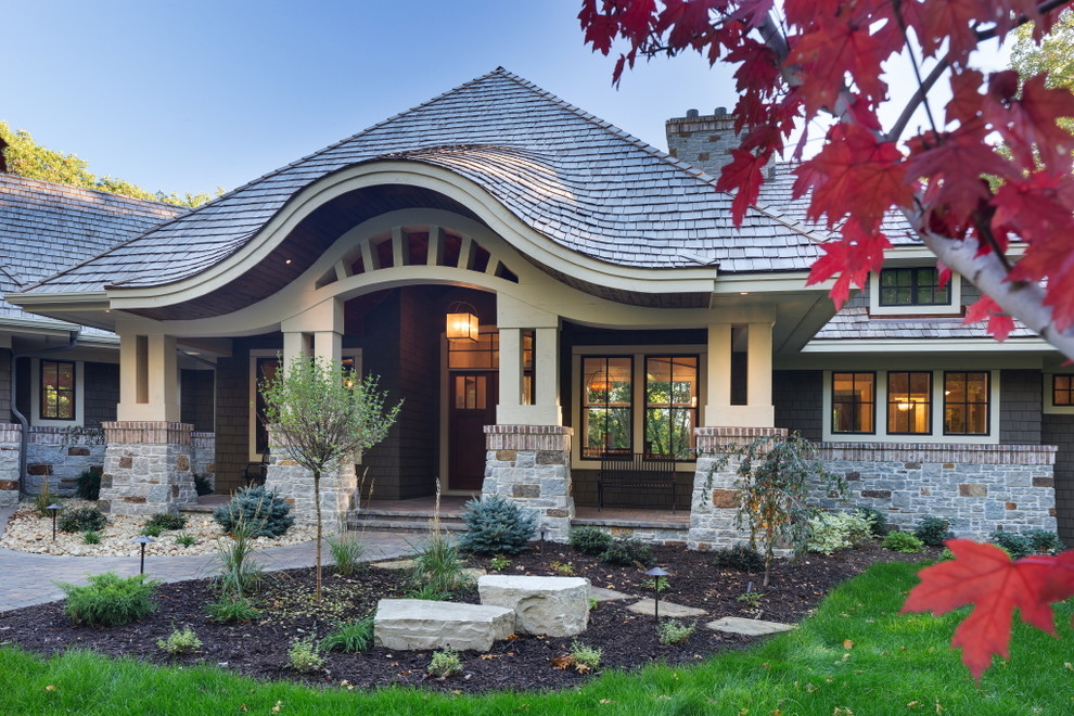 Inspiration for a transitional one-story mixed siding exterior home remodel in Minneapolis with a hip roof