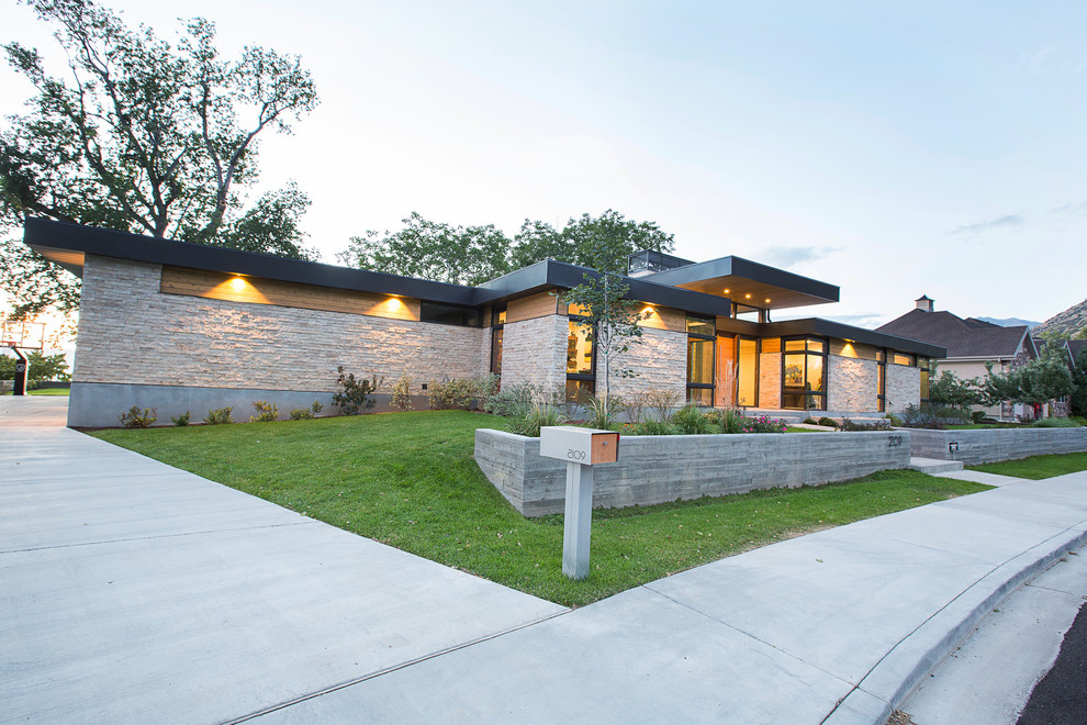 Inspiration for a mid-sized 1960s beige one-story wood exterior home remodel in Salt Lake City