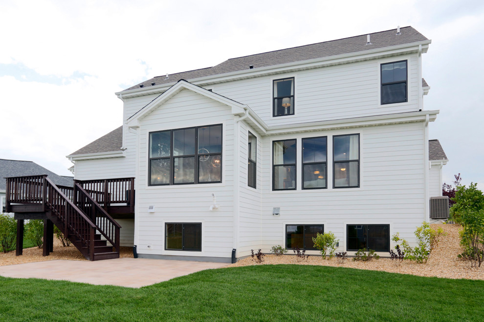 Photo of a white rural two floor house exterior in Milwaukee with vinyl cladding.