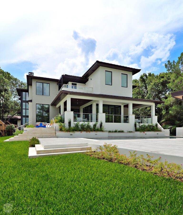 Inspiration for a large contemporary white two-story stucco flat roof remodel in Tampa
