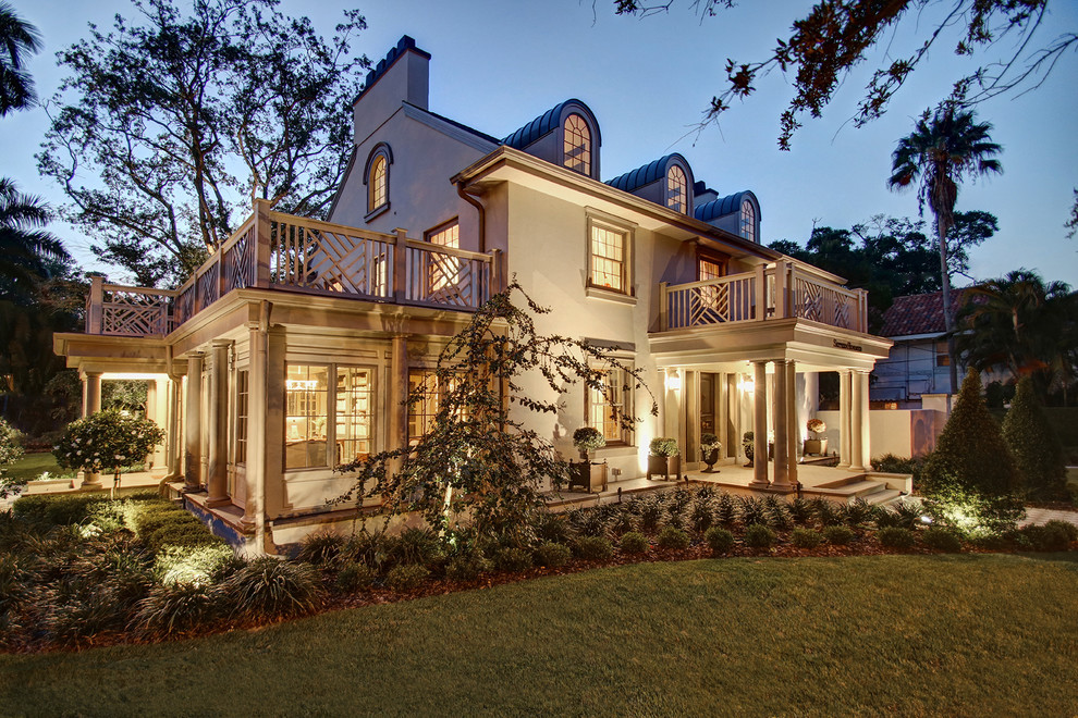 Inspiration for an eclectic beige three-story house exterior remodel in Tampa