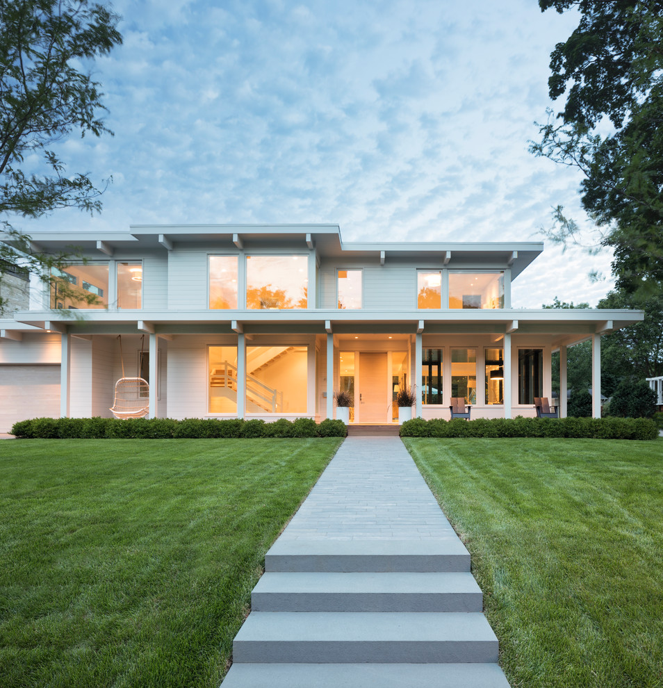 Inspiration for a white contemporary two floor house exterior in Minneapolis with a flat roof.