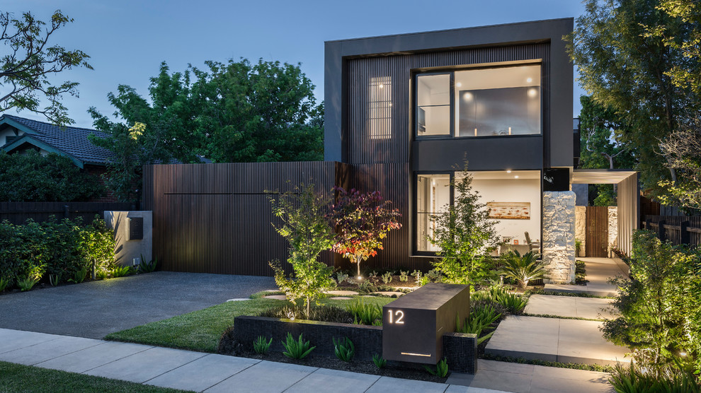 Brown contemporary two floor detached house in Melbourne with mixed cladding and a flat roof.