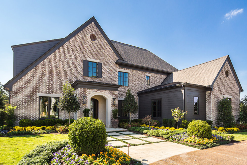 Transitional two-story brick house exterior idea in Other with a shingle roof