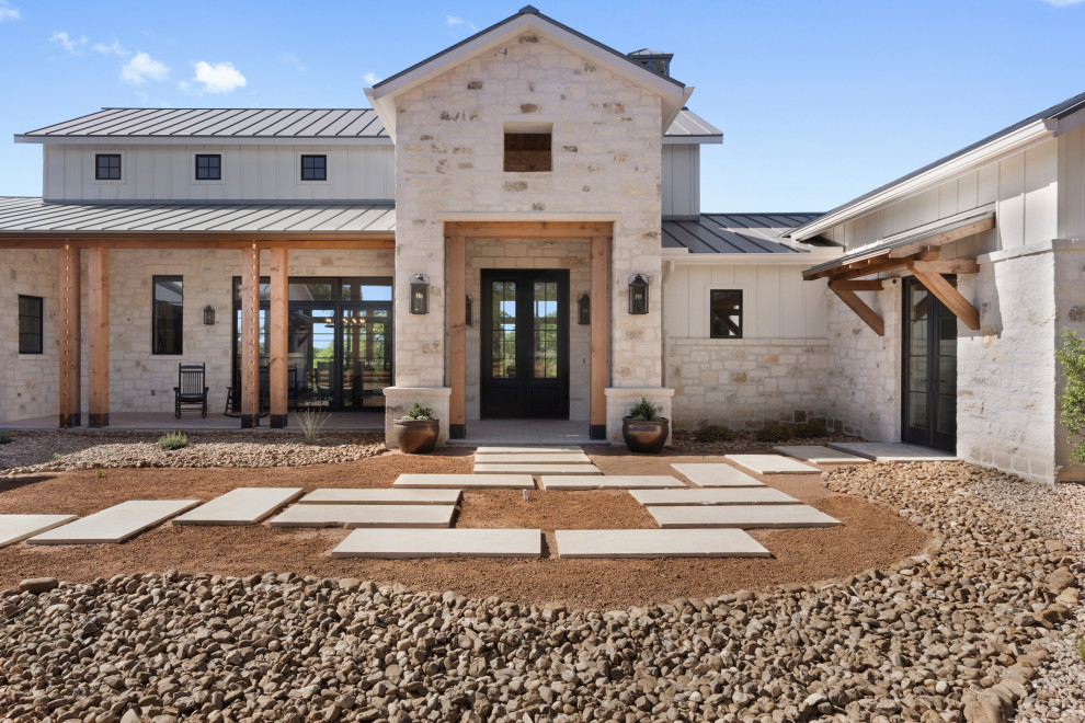 Großes, Einstöckiges Landhaus Einfamilienhaus mit Steinfassade, weißer Fassadenfarbe, Satteldach und Blechdach in Austin