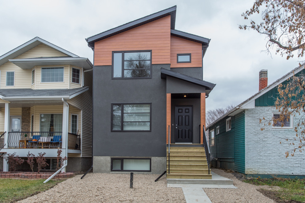 Kleines, Zweistöckiges Modernes Haus mit Putzfassade, grauer Fassadenfarbe und Flachdach in Sonstige