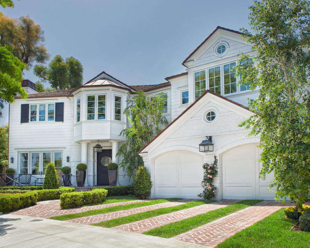Mittelgroßes, Zweistöckiges Klassisches Einfamilienhaus mit Backsteinfassade, weißer Fassadenfarbe und Schindeldach in Orange County