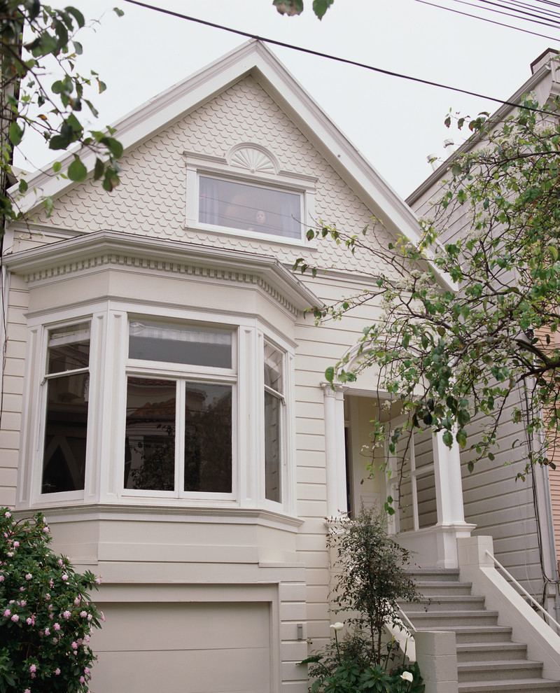 This is an example of a victorian house exterior in San Francisco with wood cladding and a pitched roof.