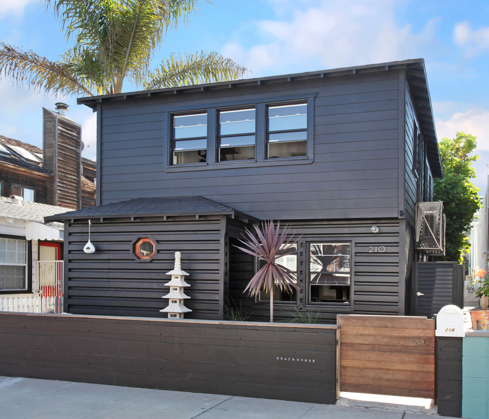 This is an example of a gey nautical two floor house exterior in Orange County.