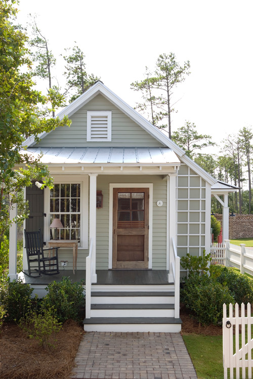 Small house with green siding and wood front door -  - mistakes first-time homebuyers should avoid