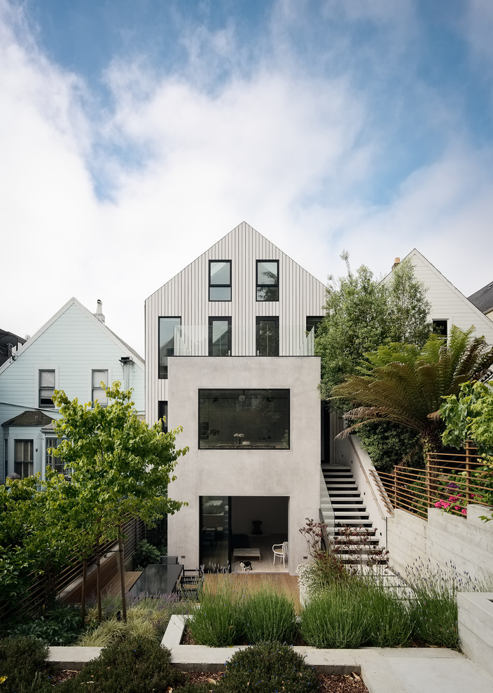 Photo of a white contemporary detached house in San Francisco with three floors, mixed cladding and a pitched roof.