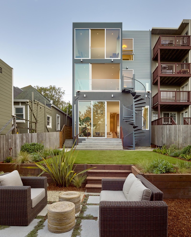 Example of a large minimalist blue three-story wood exterior home design in San Francisco with a metal roof