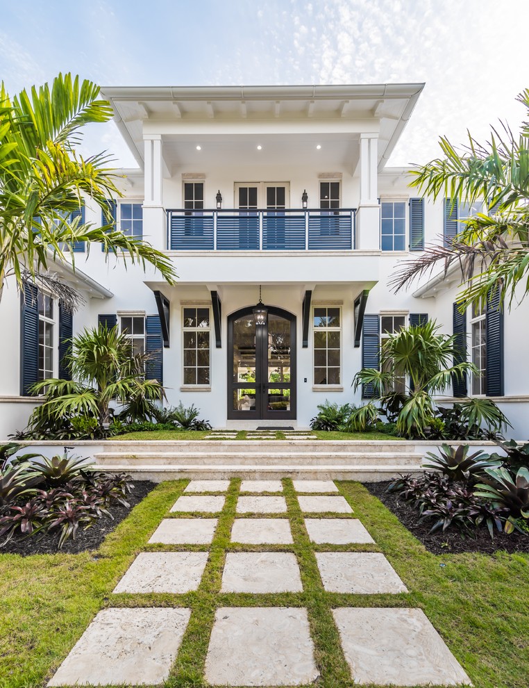 Island style white two-story exterior home photo in Miami