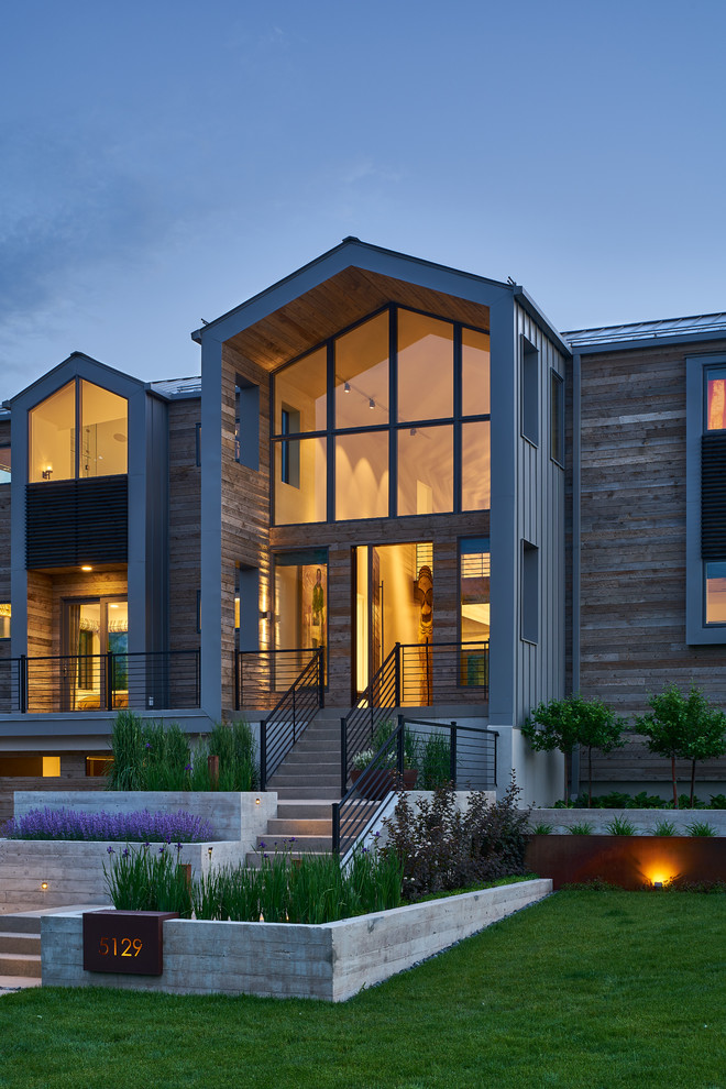 This is an example of a large and brown contemporary two floor detached house in Salt Lake City with wood cladding and a pitched roof.