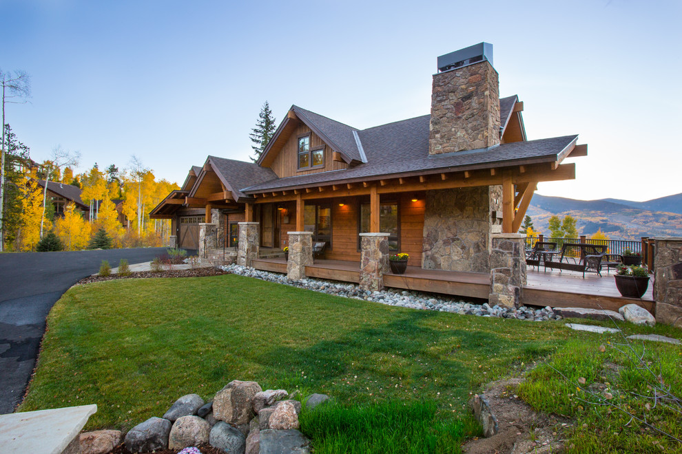 Large mountain style brown two-story mixed siding exterior home photo in Denver with a shingle roof