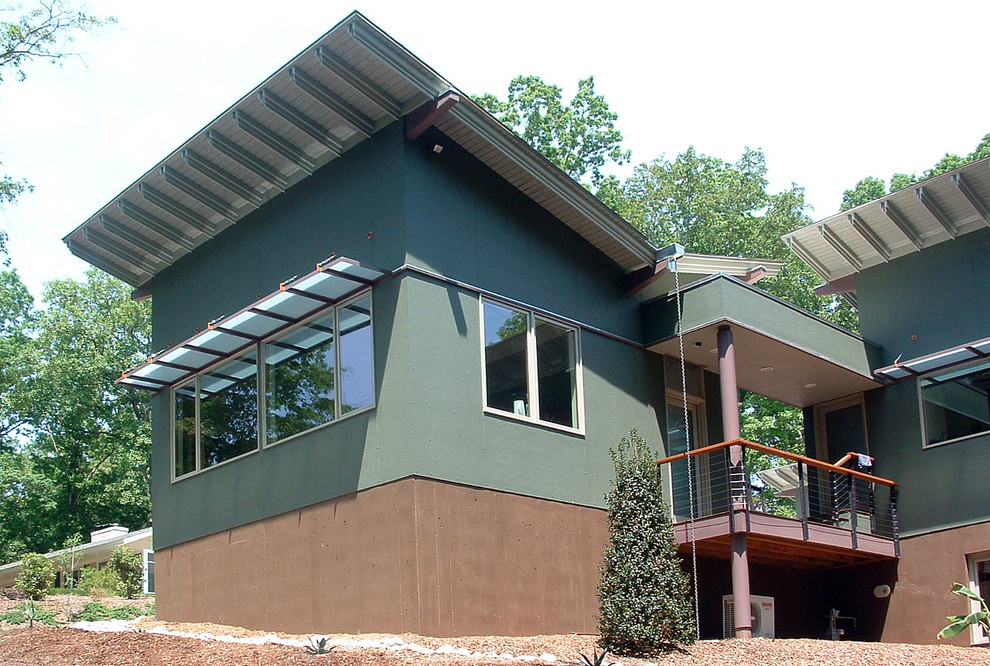 Inspiration for a huge modern multicolored one-story mixed siding house exterior remodel in Raleigh with a shed roof and a metal roof
