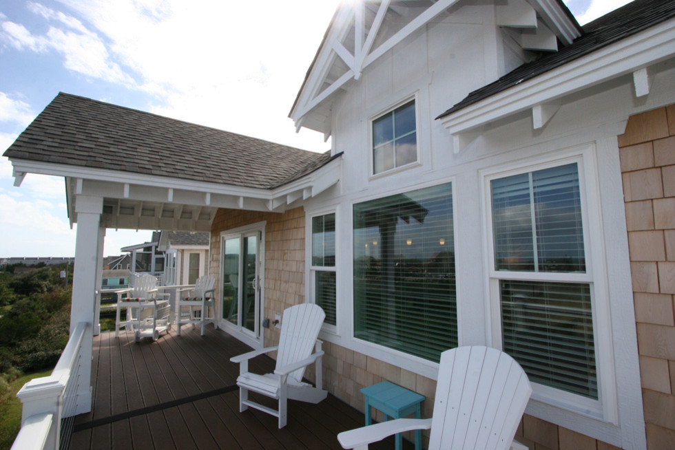 Inspiration for a mid-sized coastal beige three-story wood gable roof remodel in Other