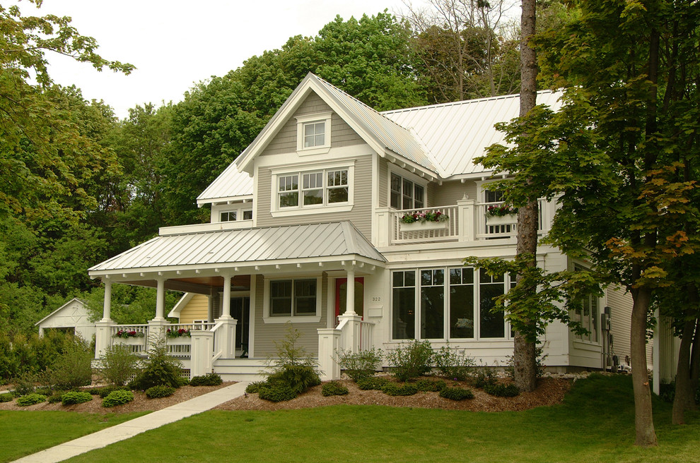 Cette photo montre une façade de maison chic en bois avec un toit en métal.