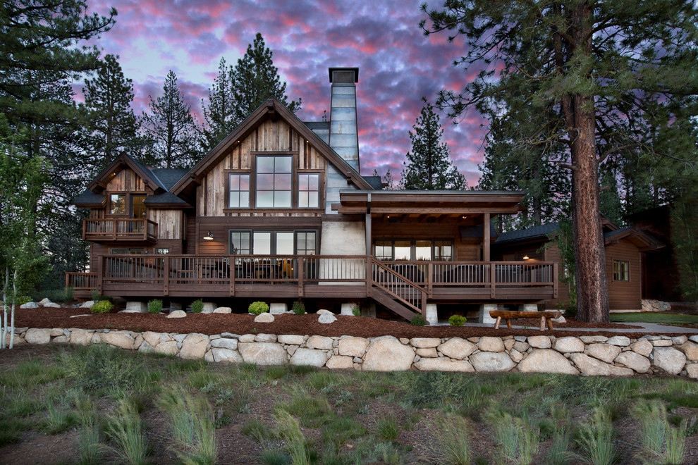 Design ideas for a rustic two floor house exterior in Sacramento with wood cladding and a pitched roof.