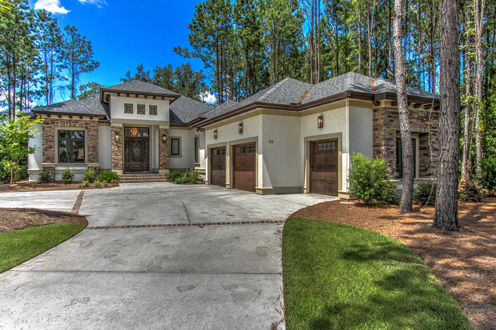 Inspiration for a mid-sized transitional white two-story stucco house exterior remodel in Atlanta with a hip roof and a shingle roof