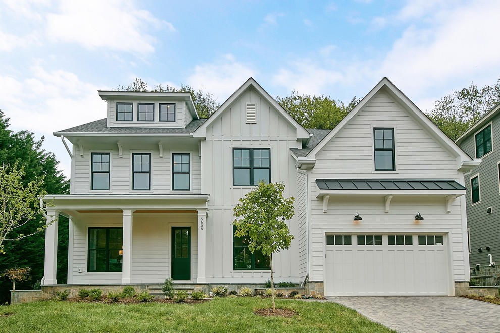 Photo of a large and white country detached house in DC Metro with three floors, concrete fibreboard cladding, a pitched roof and a mixed material roof.