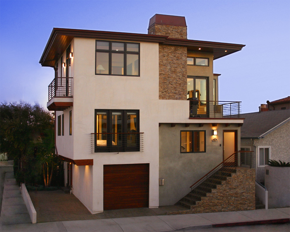 Cette image montre une grande façade de maison blanche design à deux étages et plus avec un revêtement mixte et un toit plat.