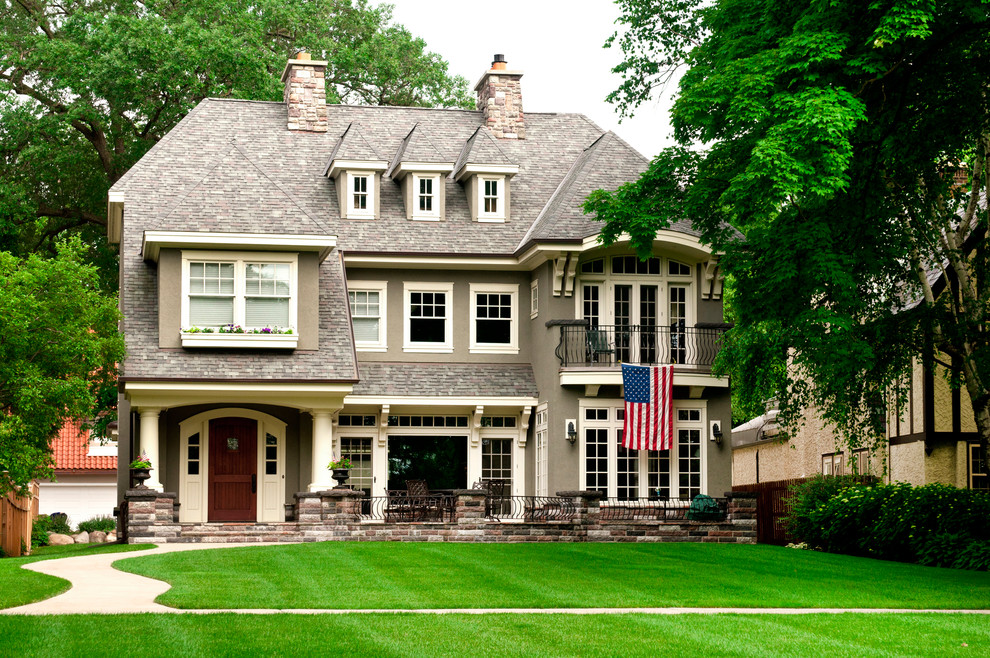 Elegant gray three-story house exterior photo in Other with a hip roof and a shingle roof
