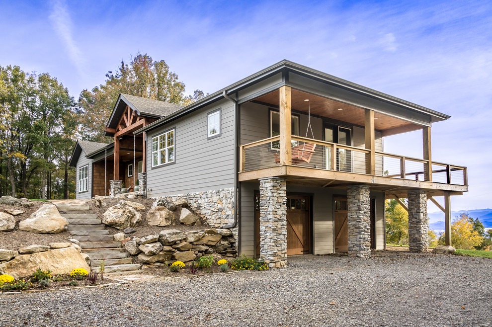 Example of a large mountain style gray two-story concrete fiberboard exterior home design in Other with a shingle roof