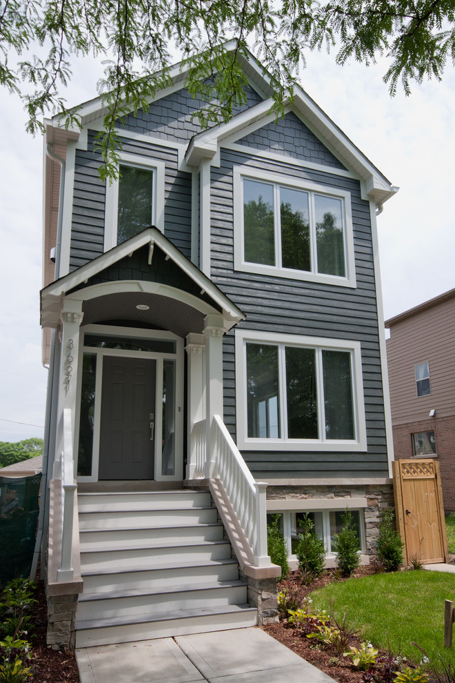 Diseño de fachada de casa azul contemporánea pequeña de dos plantas con tejado a dos aguas y tejado de teja de madera