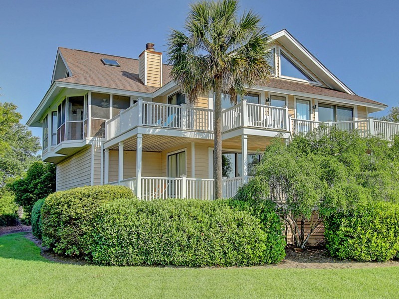 Photo of a beach style house exterior in Charleston with three floors.