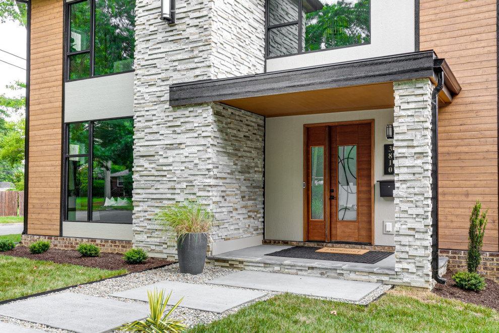 Inspiration for a mid-sized mid-century modern multicolored two-story mixed siding exterior home remodel in Richmond with a shingle roof