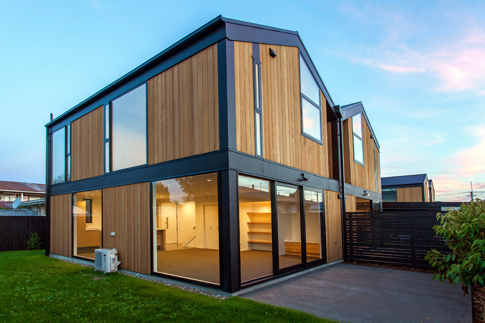 Modern two floor house exterior in Christchurch with wood cladding and a pitched roof.