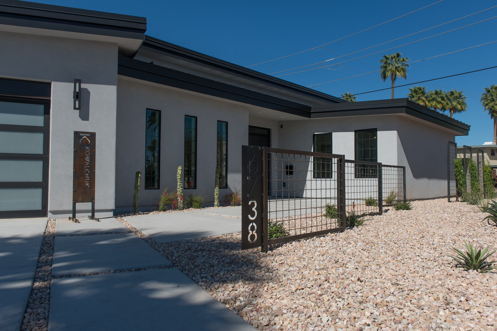 Mid-sized industrial white one-story stucco house exterior idea in Phoenix with a metal roof