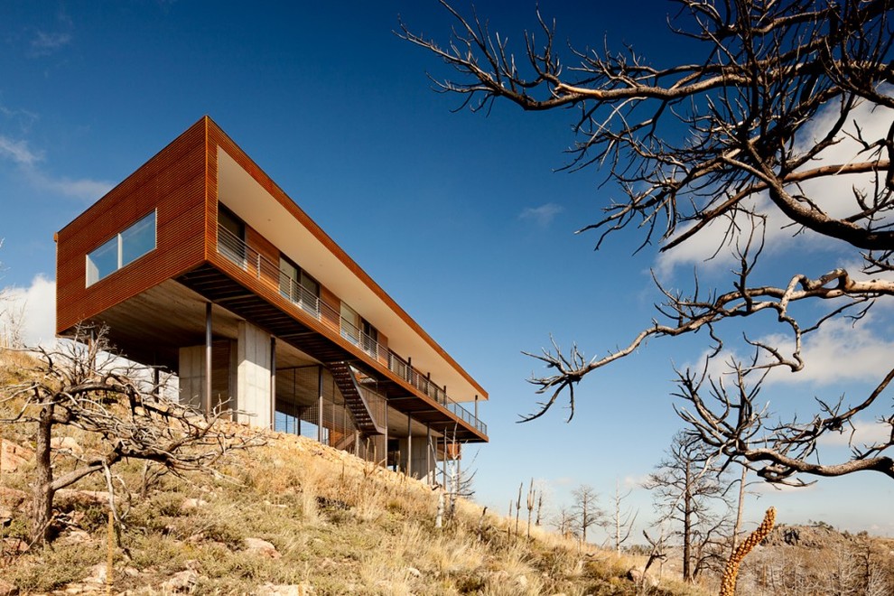 Inspiration for an industrial wood flat roof remodel in Denver