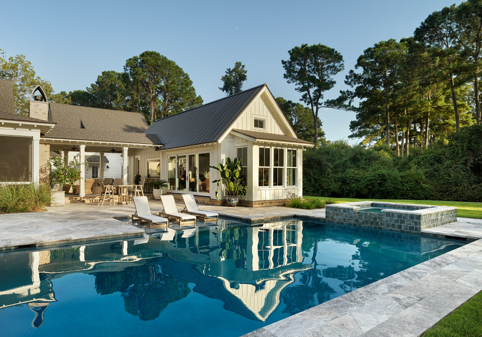 Large beach style white two-story wood exterior home photo in Charleston with a mixed material roof