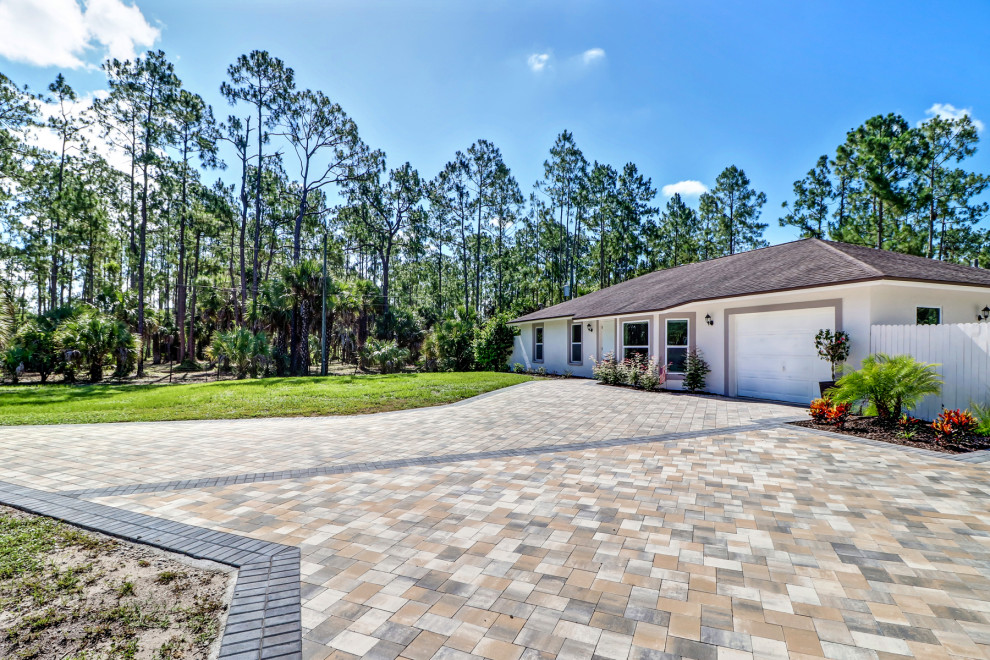 Large country white one-story concrete exterior home photo in Other with a shingle roof