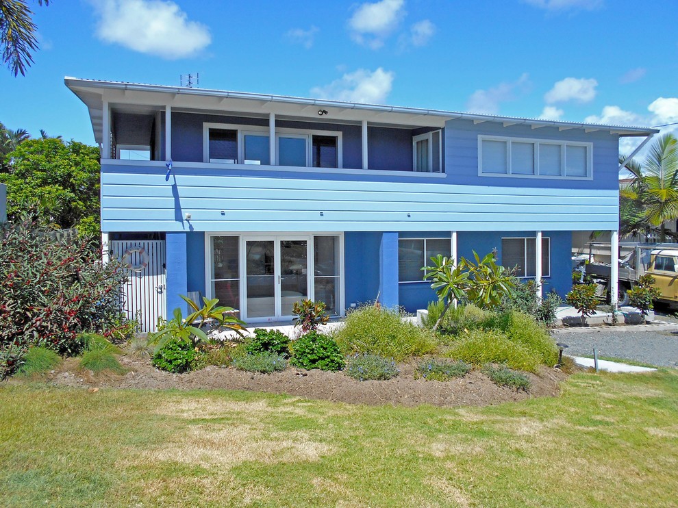 Inspiration for a small and blue nautical two floor house exterior in Sunshine Coast with wood cladding.