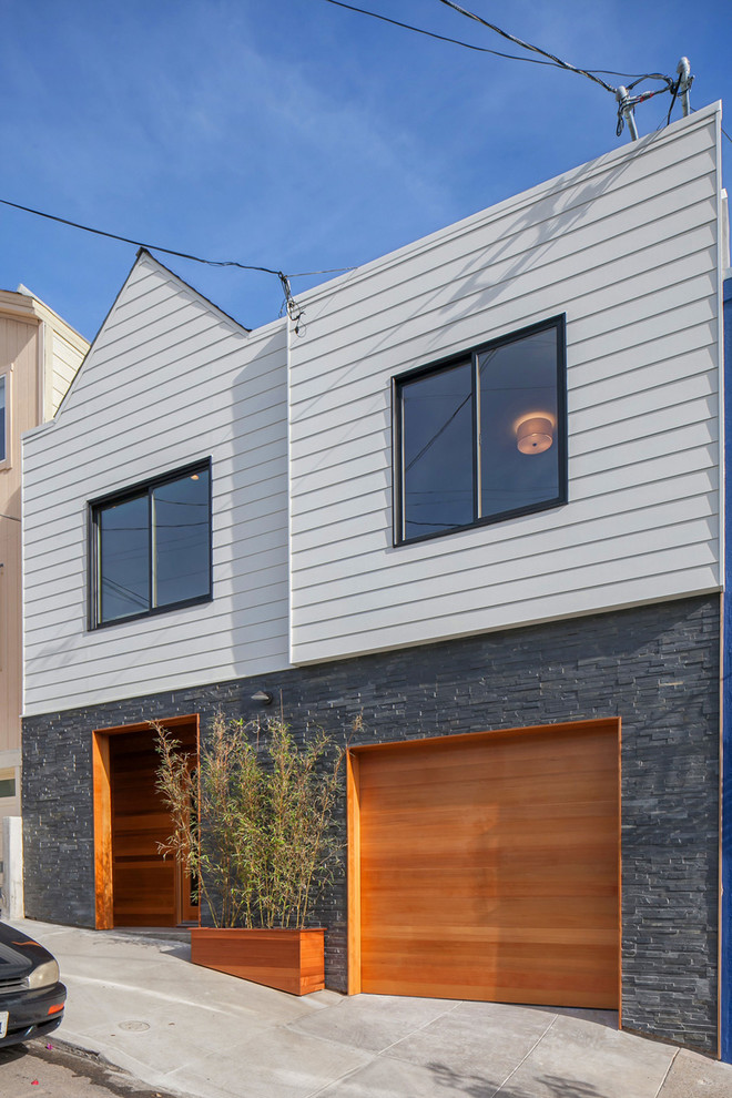 Example of a trendy black two-story stone exterior home design in San Francisco