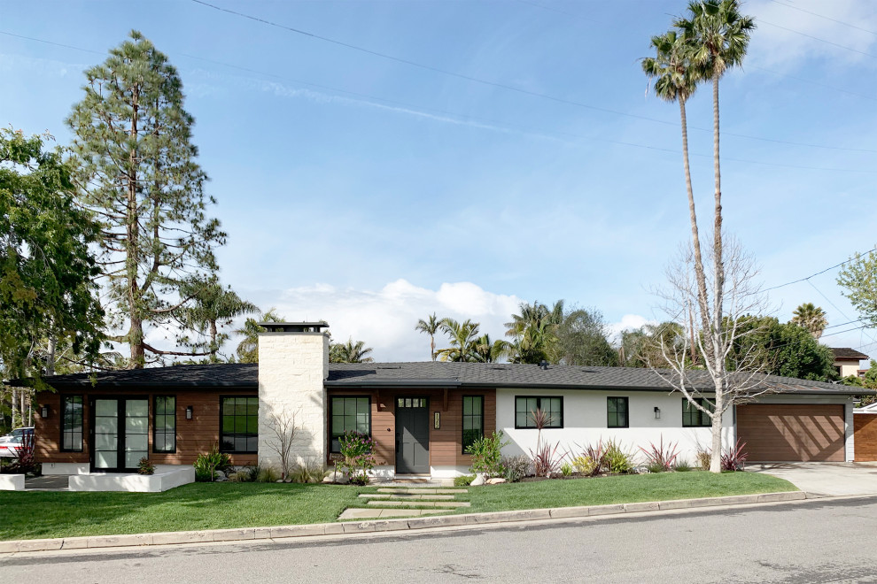 Example of a 1950s white one-story wood house exterior design in Orange County