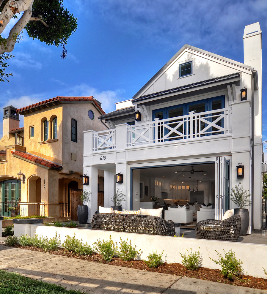 Large coastal white two-story stucco exterior home idea in Los Angeles