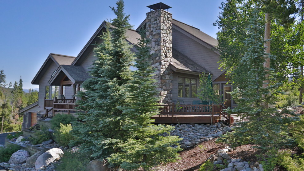 Example of a large trendy gray three-story wood exterior home design in Denver